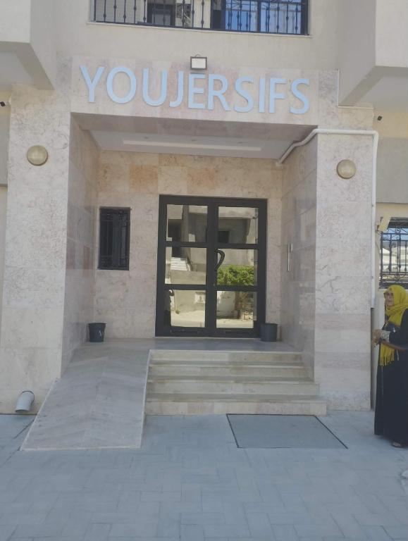 a woman standing in front of a building at Nozeht el soltan in Potinville