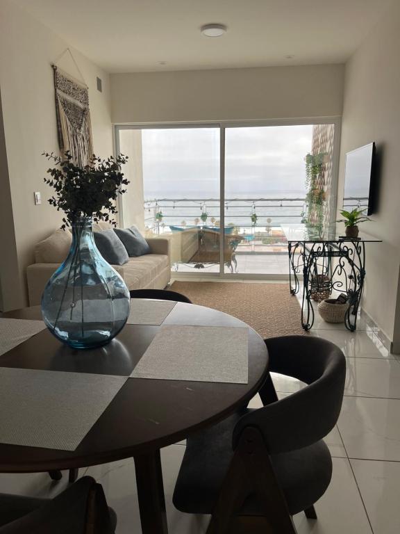a living room with a table with a vase on it at Rosarito Sol y Mar Getaway in Rosarito Beach