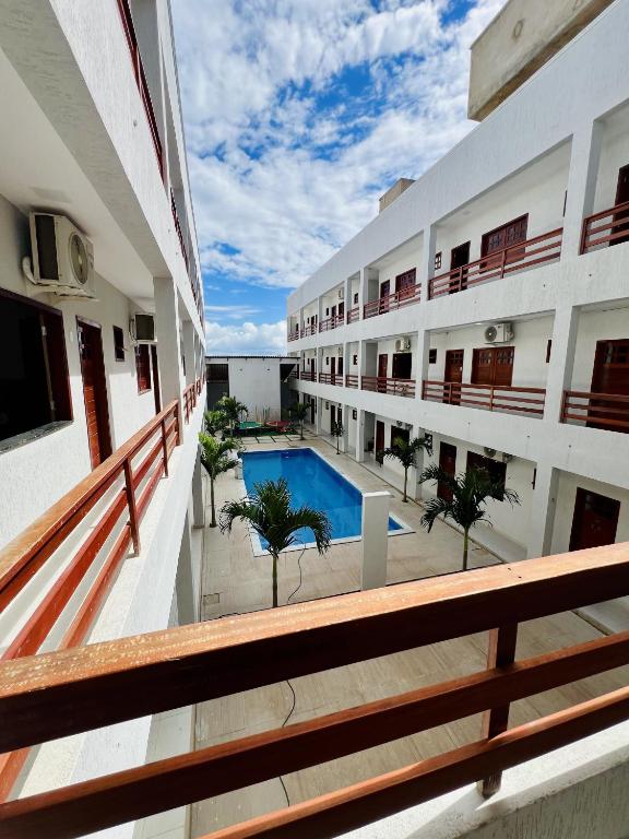 a view from the balcony of a building with a swimming pool at Flat completo em condomínio in Camocim
