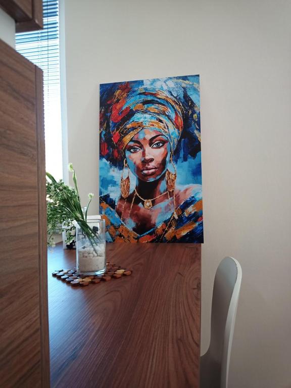a painting of a woman on a table in a room at Urban Boutique Apartments in Bitola