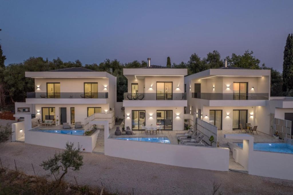 a large white house with two swimming pools at Zandore Villas Perdika private Luxury Villas Epirus Villas in Pérdika