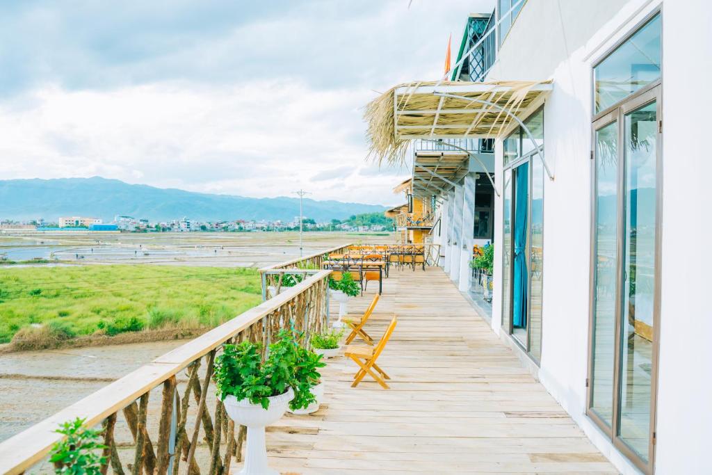 a balcony of a hotel with tables and chairs at Mường Thanh Garden Stay in Dien Bien Phu