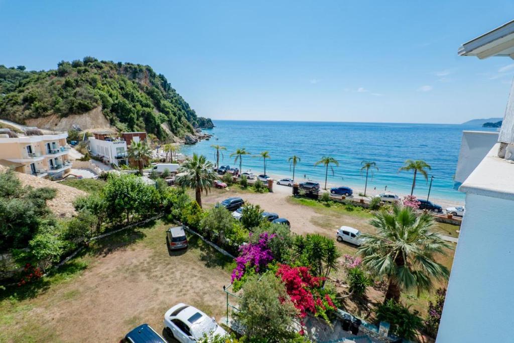 a view of a beach with palm trees and the ocean at Blue Stay Boutique Hotel in Himare