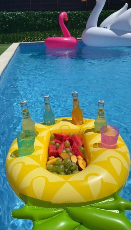 a pool with a tray of fruit and drinks at Kelesina Apartment in Ulcinj