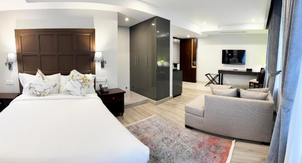 a bedroom with a bed and a living room at Pak Hospitality in Islamabad