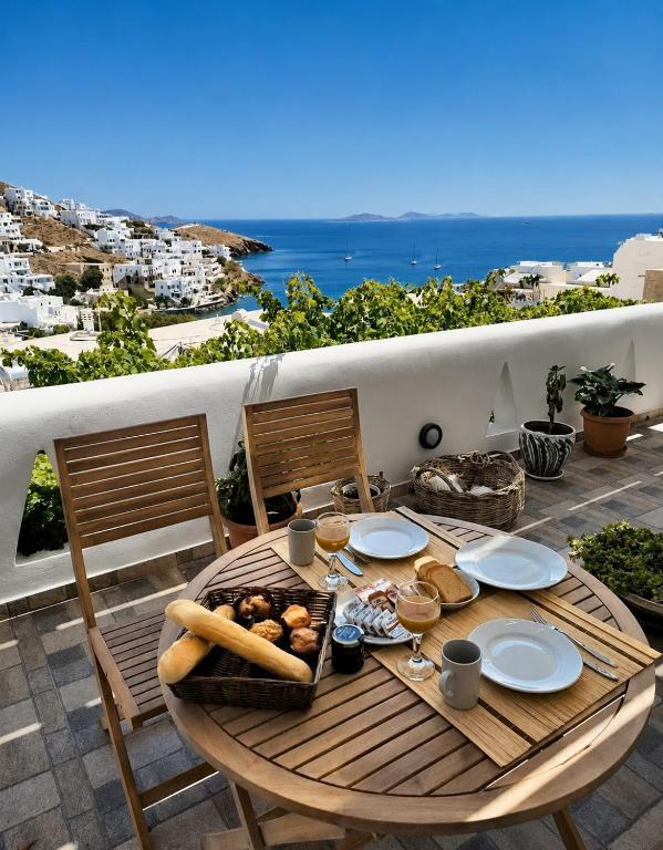a wooden table with food on top of a balcony at Primrose Apartments in Astypalaia