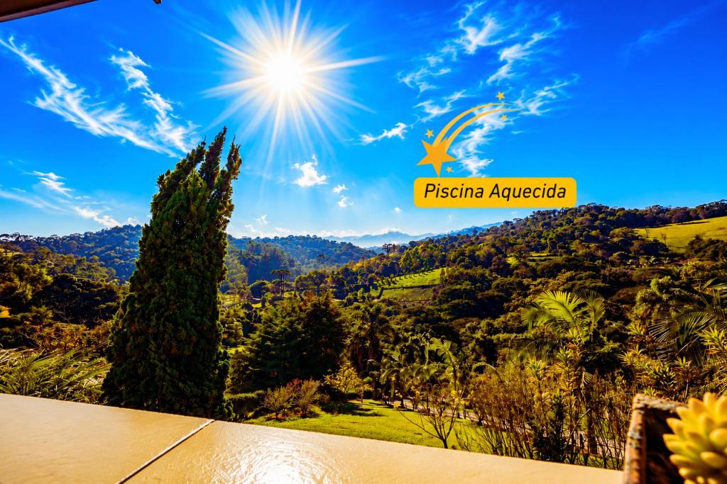 a view of a mountain with the sun in the sky at Refugio nas Alturas LANDIN & CHARM in Santo Antônio do Pinhal