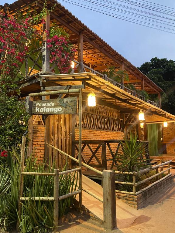 a wooden building with a sign in front of it at Pousada Kalangoo in Barra Grande