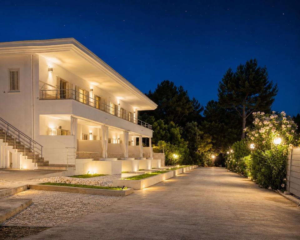 a white building with lights in the night at Petra Maris B&B in Peschici