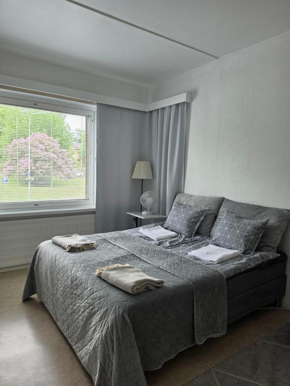 a bedroom with a bed with two towels on it at Central Accommodation at Olavinkatu in Savonlinna