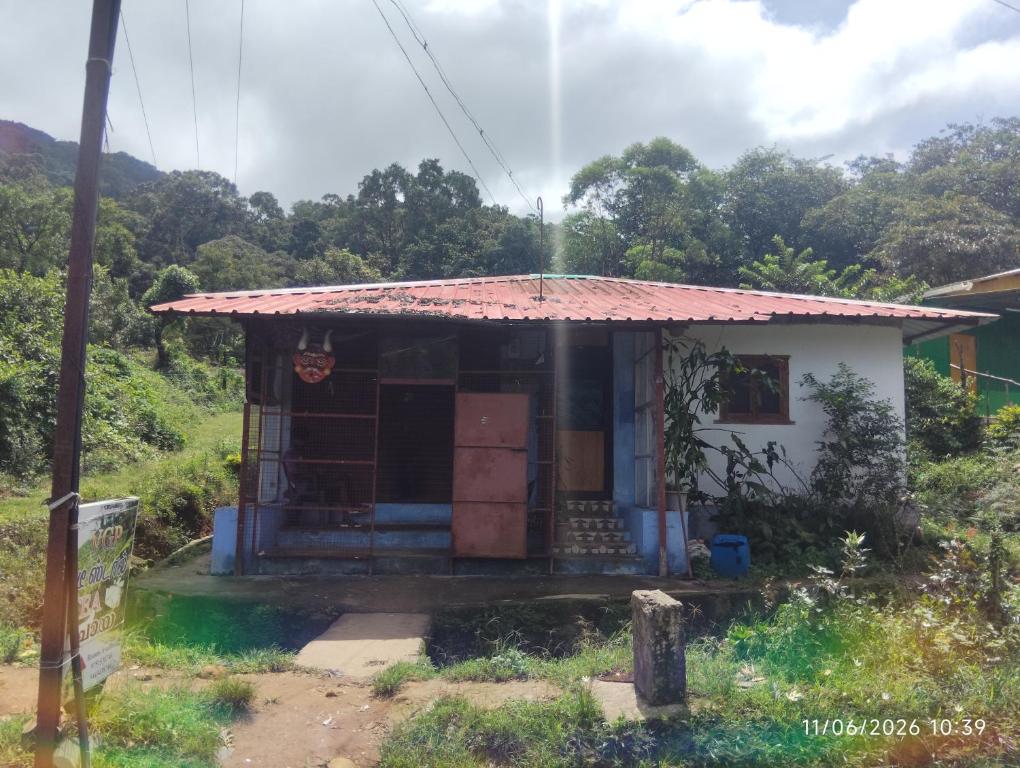a small house with a red roof at Tvkhomestay in Vālpārai