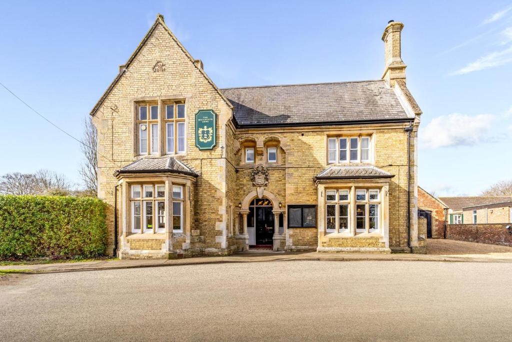 an old brick building with a sign on it at Whichcote Arms Hotel in Sleaford