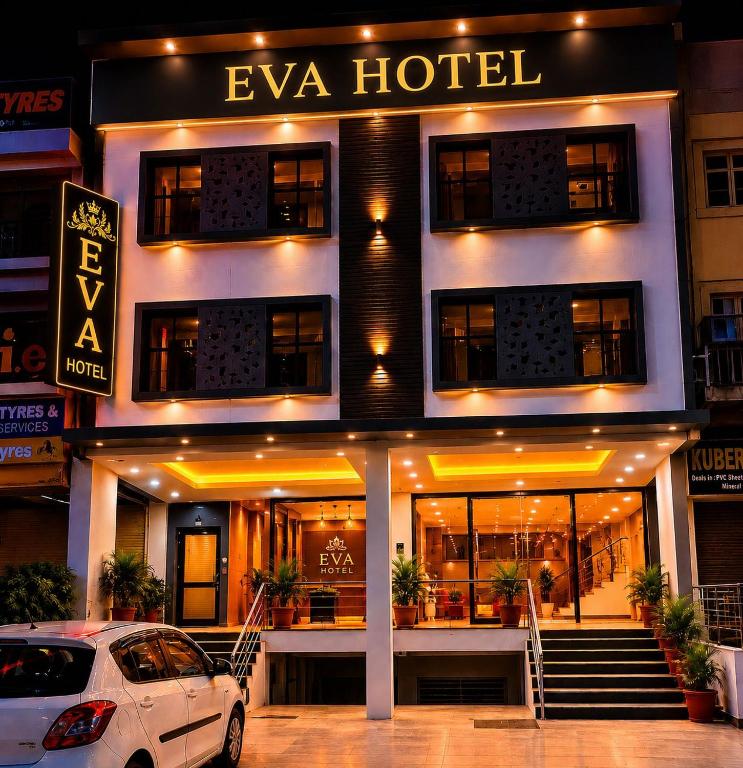 a white car parked in front of a hotel at Eva Hotel in Zirakpur