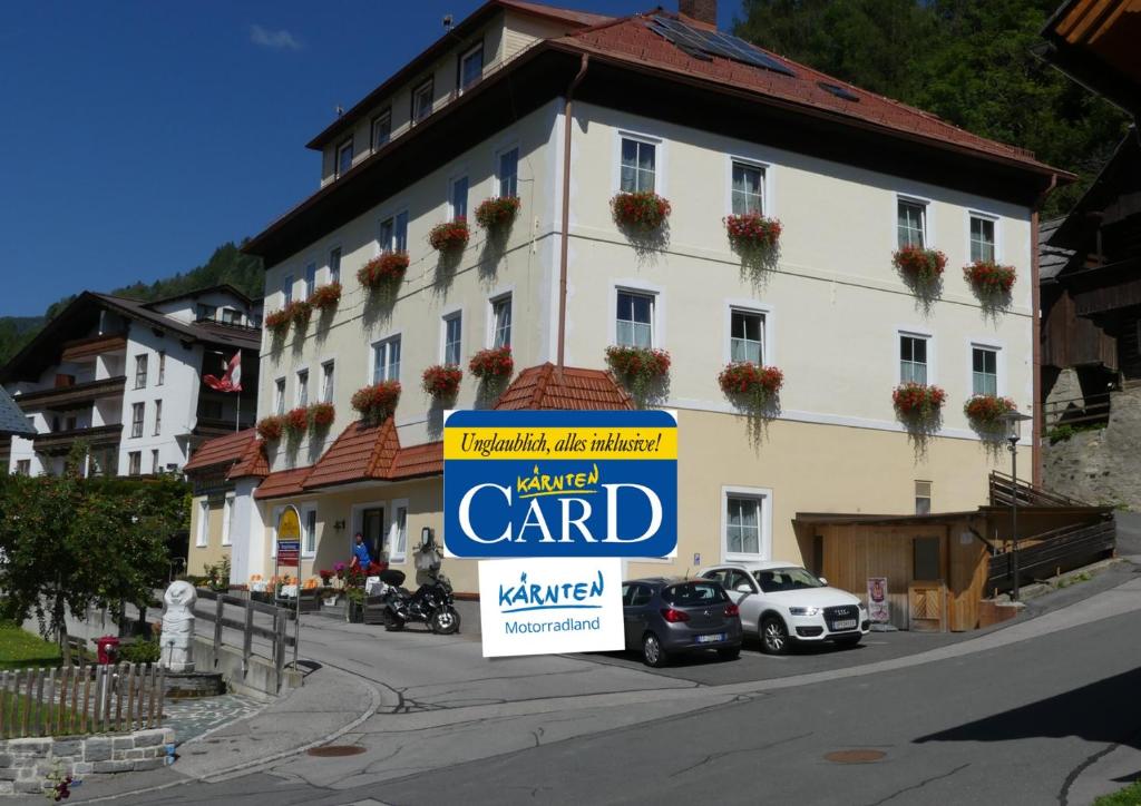 a large building with a sign in front of it at Hotel Kirchenwirt in Bad Kleinkirchheim