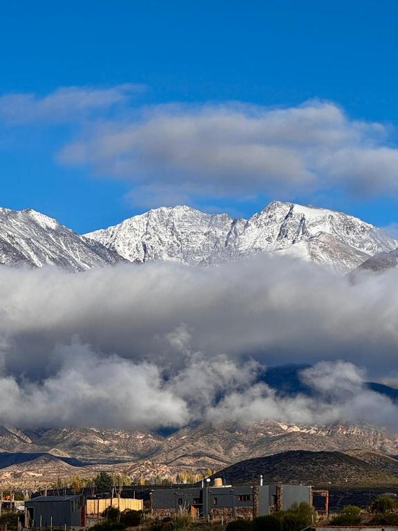 a group of snow covered mountains in the distance at Tierra Potrerillos in Potrerillos