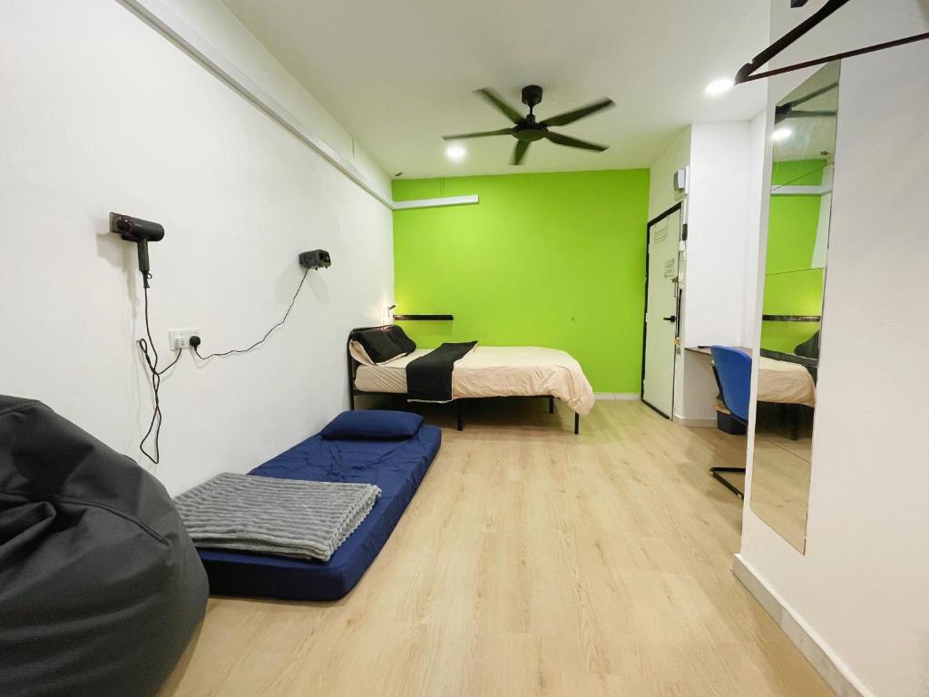 a room with a bed and a green wall at D Cloud Homestay & Room in Kajang