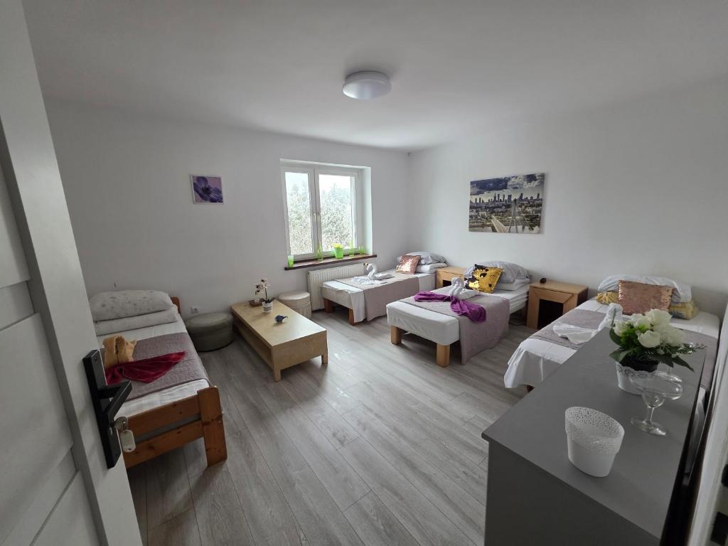 a large living room with chairs and a table at Ночлеги - Pokoi in Tarnowo Podgórne