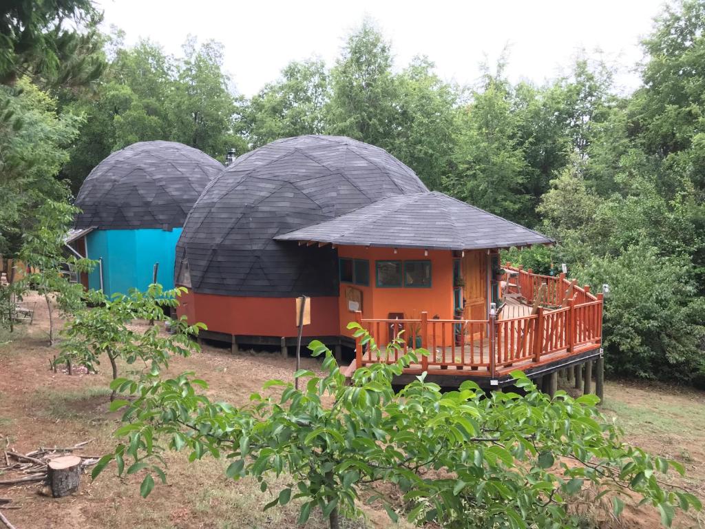 a small house with two domes in a yard at Chakana Newen Refugio in San Clemente