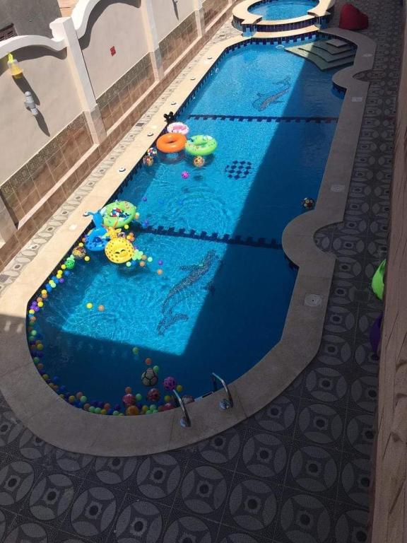 a large swimming pool with a toy in the water at Qasr Diana in Marsa Matruh