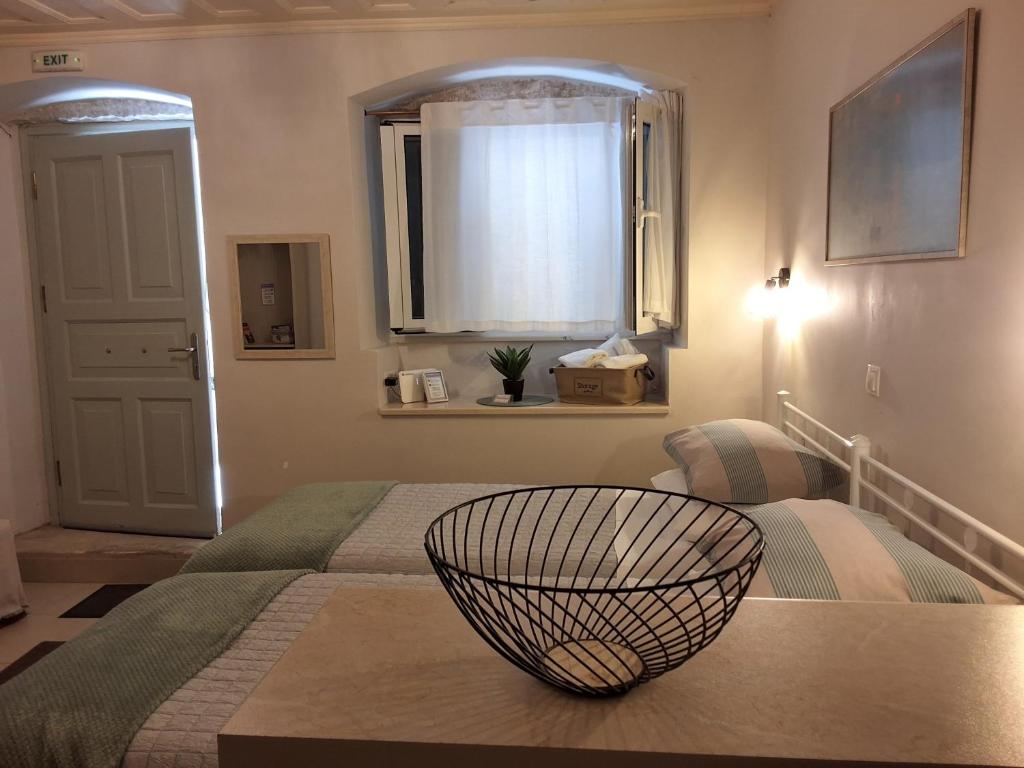 a bedroom with a bed with a bowl on it at Studio CASINELLA in Corfu
