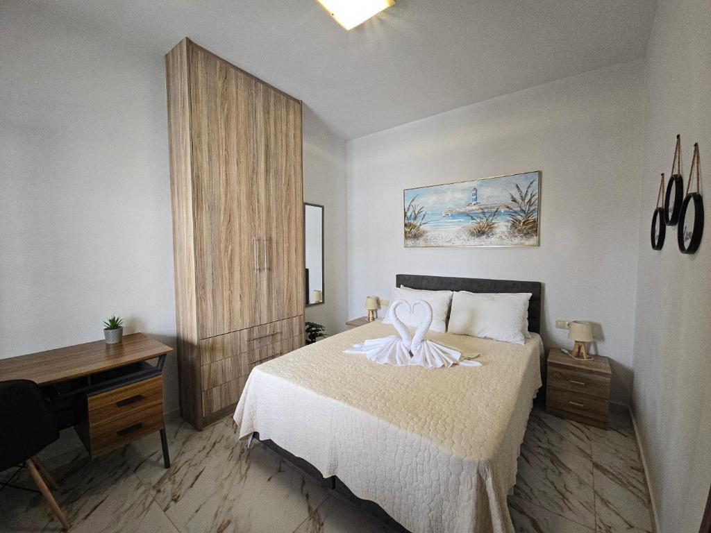 a bedroom with a bed and a desk in it at Maitos Apartments in Galanádhon