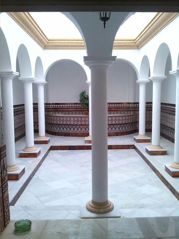 a large room with white columns in a building at Apartamentos Lebrero in San Fernando