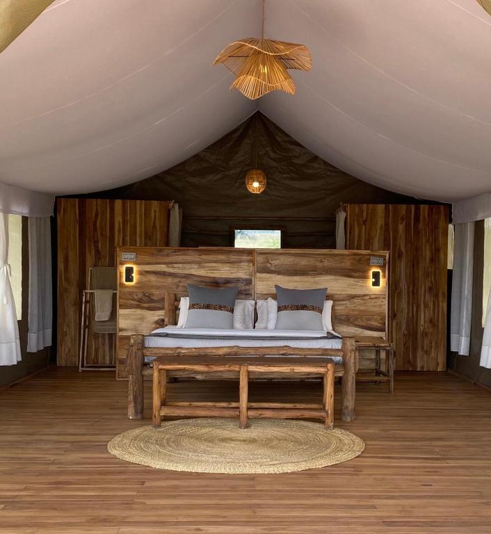 a bedroom with a bed in a tent at Zawadi Serengeti camp in Serengeti National Park