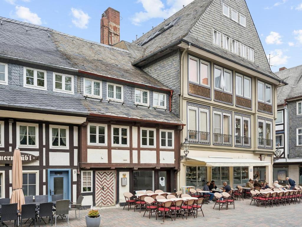 a large building with tables and chairs in a courtyard at Auszeit in Goslar