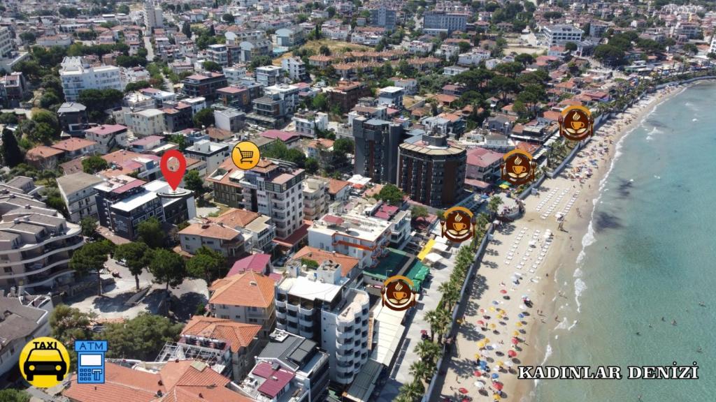an aerial view of a beach with buildings and a city at AC Konaklama in Kuşadası