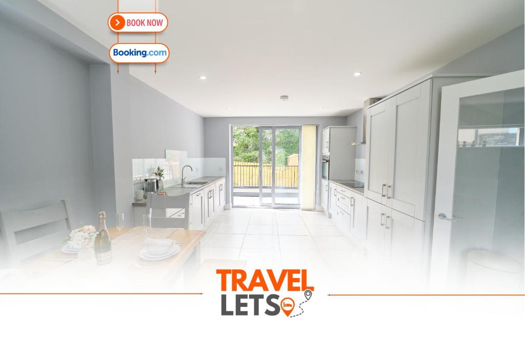 a kitchen with white cabinets and an open door at 3 Bedroom Duplex Apartment By Travel Lets Short Term Rental Agency Donegal Town in Donegal