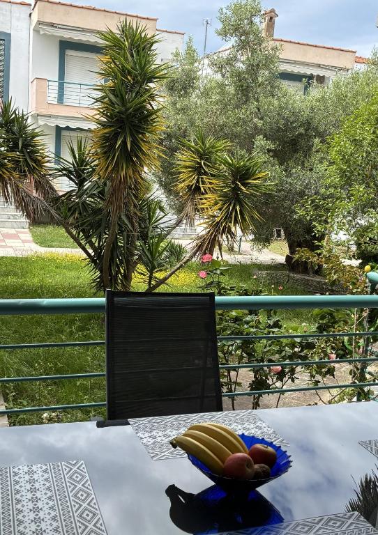 a table with a bowl of bananas and fruit on it at Pefkostalia in Pefkochori