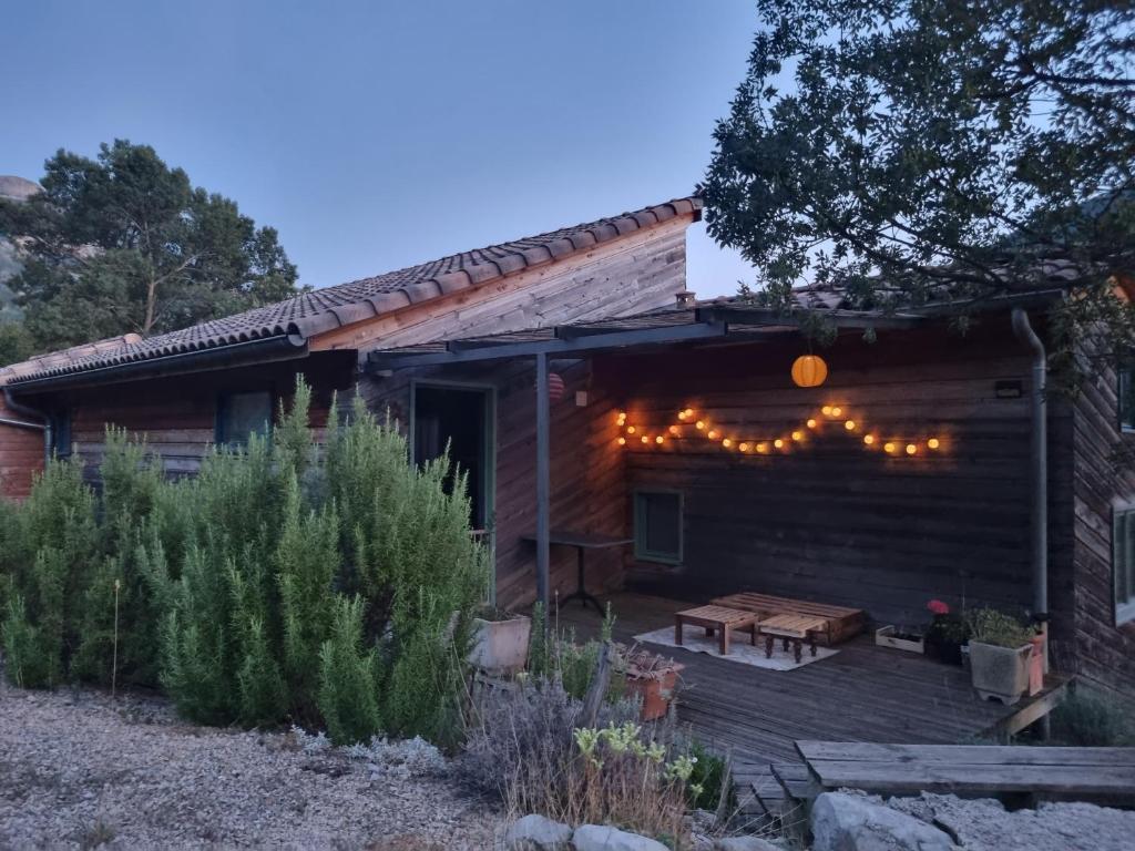 a house with a deck with lights on it at Chambres d'hôtes " Casa della Felicità " in La Roche-sur-le-Buis
