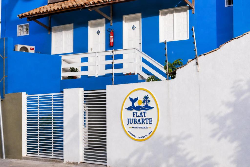 a blue building with a sign that reads hair warehouse at Flat Jubarte Praia do Francês in Marechal Deodoro