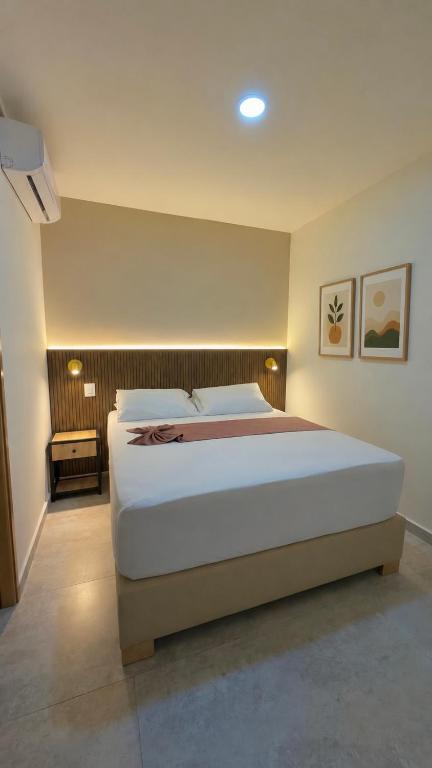 a bedroom with a large white bed in a room at Hotel Nakama in Medellín