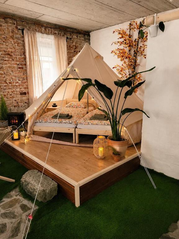 a bedroom with a bed in a tent at Pajtl indoor glamping in Črna na Koroškem