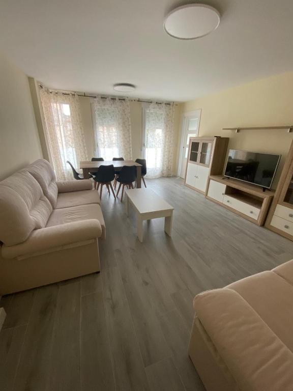 a living room with a couch and a table at Apartamento Chicuelo in Ariza