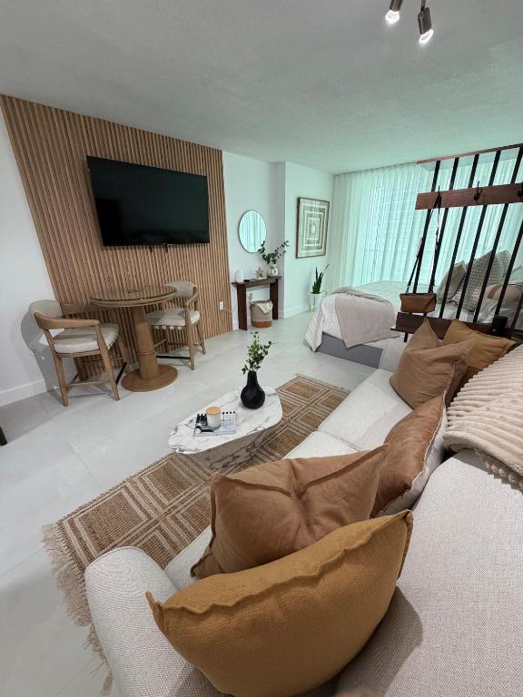 a living room with a couch and a flat screen tv at Luxury executive Studio in Brickell in Miami