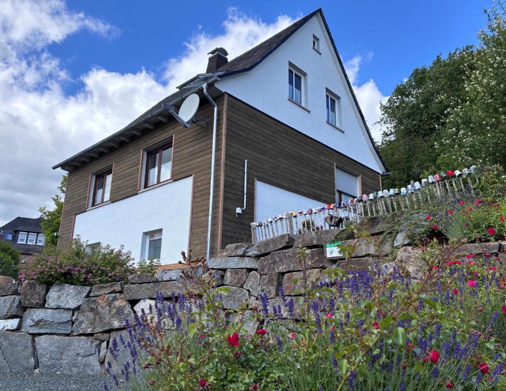 a house on top of a stone wall at Apartmenthaus RuheZeit in Bad Endbach