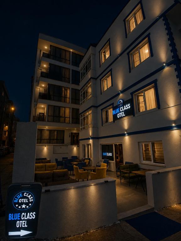 a building with a blue glass chef sign in front of it at Blue class otel in Atakum