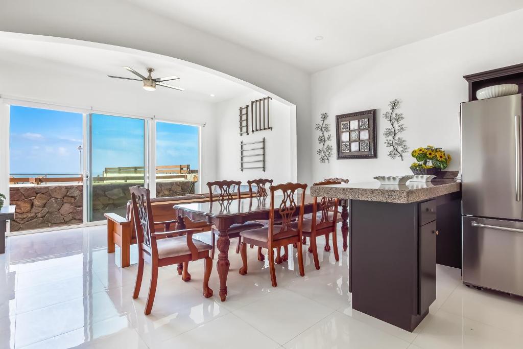 a kitchen and dining room with a table and chairs at Dog-Friendly Ocean-View Home with Heated Outdoor Pool, Hot Tub, Streaming, Patio in Rosarito