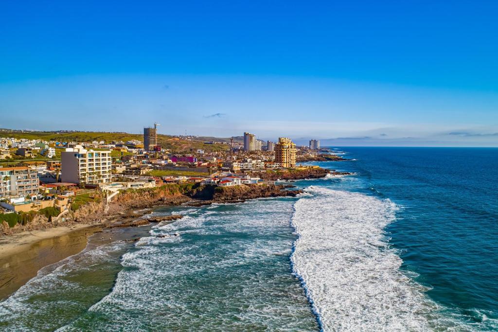 an aerial view of a beach with buildings and the ocean at Dog-Friendly Suite with Kitchenette, Heated Outdoor Pool, Hot Tub, Terrace, AC in Rosarito
