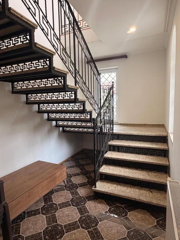 a staircase in a home with a tiled floor at Sunny Home Digomi 7 in Tbilisi City