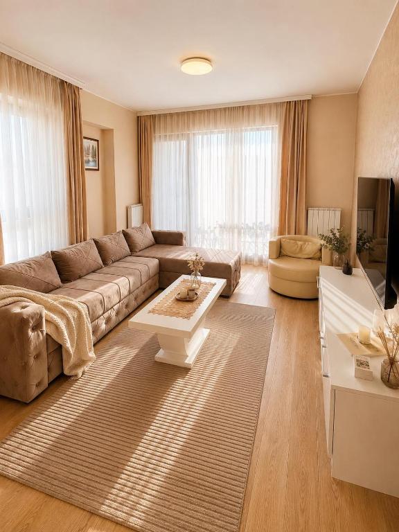 a living room with a couch and a table at Aria Lux Belgrade Waterfront in Belgrade