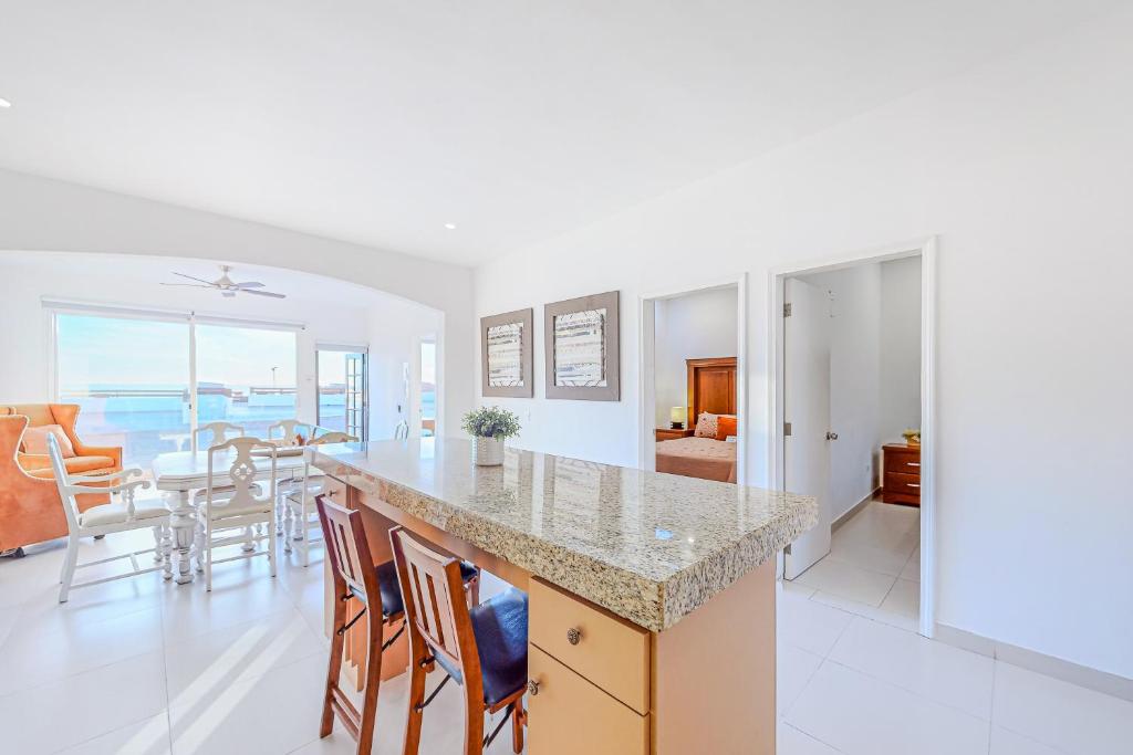 a kitchen and dining room with a view of the ocean at Dog-Friendly Villa with Heated Outdoor Pool, Hot Tub, Streaming, Balcony, Grill in Rosarito