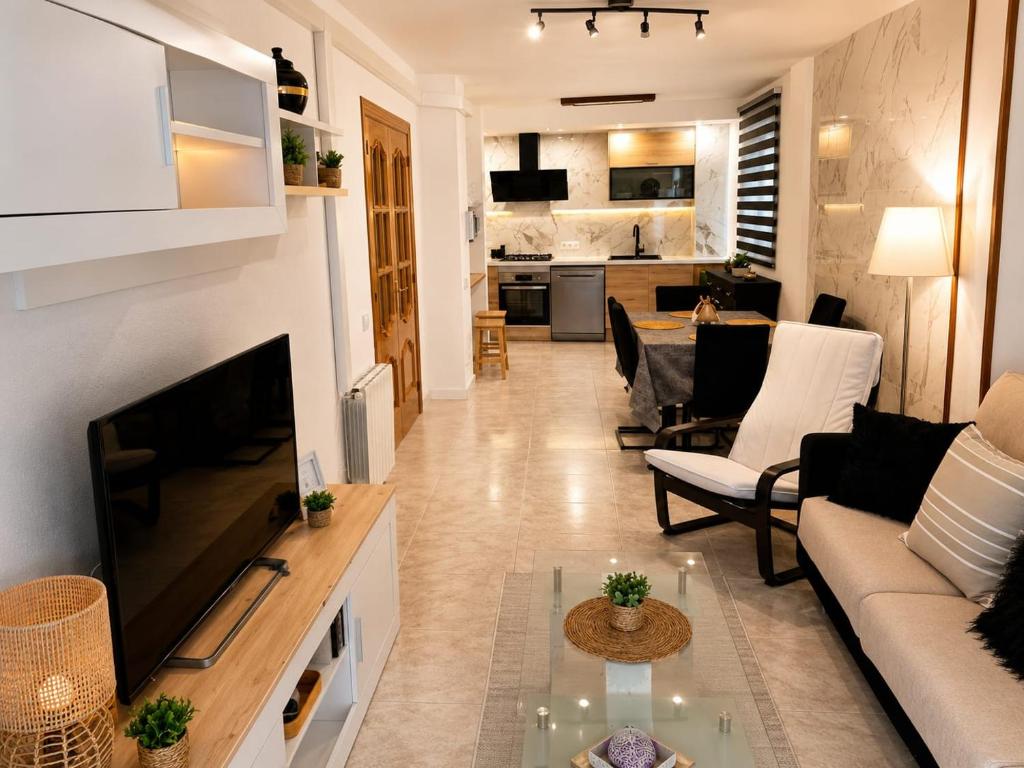 a living room with a couch and a tv at Precioso apartamento de lujo in Torredembarra