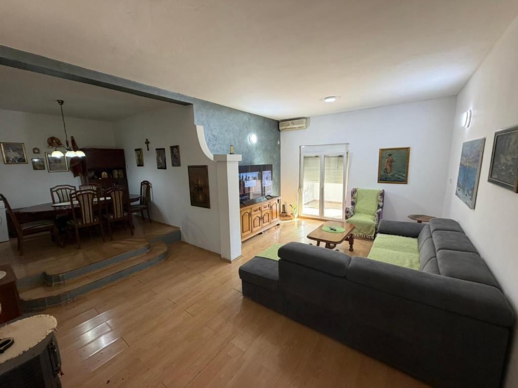 a living room with a couch and a dining room at Home Two Brothers in Bar