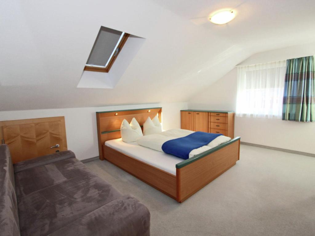 a bedroom with a bed and a couch at Chalet in Fiss near Ski Lifts in Fiss