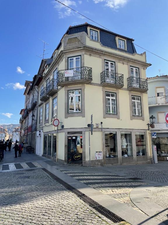a tall building on a city street at Ponte Romana in Chaves