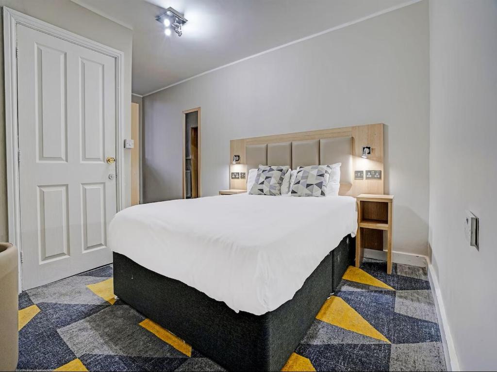 a bedroom with a large bed in a room at Dream Hotel in Manchester
