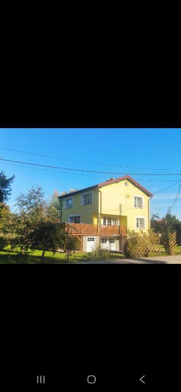 a large house in front of a house at Dom Na Fali in Pasym
